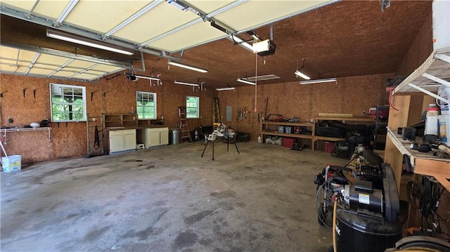 3122 Harmony Rd, Temple, GA 30179 - garage featuring a workshop area and a garage door opener