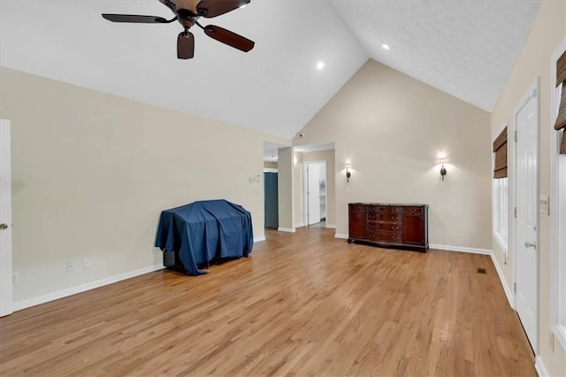 3122 Harmony Rd, Temple, GA 30179 - unfurnished living room with high vaulted ceiling, a ceiling fan, and light wood-type flooring