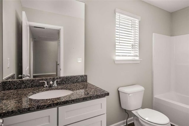 full bath featuring toilet, vanity, shower / bathing tub combination, and baseboards