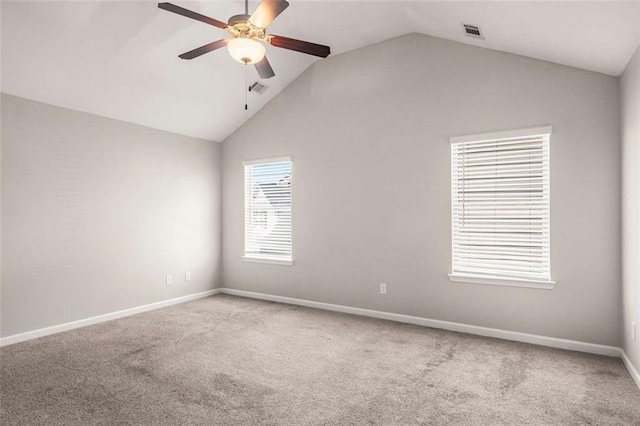 carpeted empty room with a ceiling fan, baseboards, lofted ceiling, and visible vents