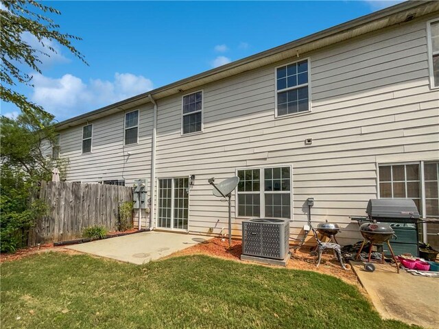 back of property featuring a patio area, central air condition unit, and a lawn