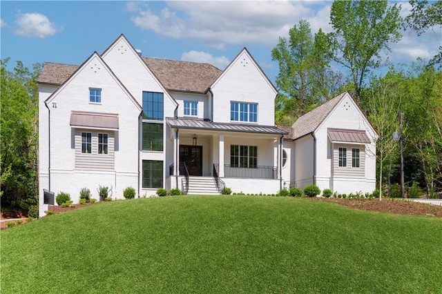 541 Londonberry Rd, Atlanta, GA 30327 - view of front of home with a porch, a standing seam roof, a front yard, brick siding, and metal roof