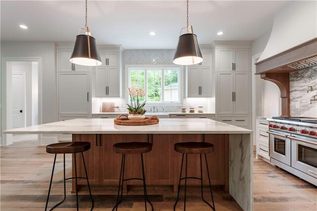 541 Londonberry Rd, Atlanta, GA 30327 - kitchen with custom range hood, double oven range, light wood-style flooring, white cabinets, and recessed lighting
