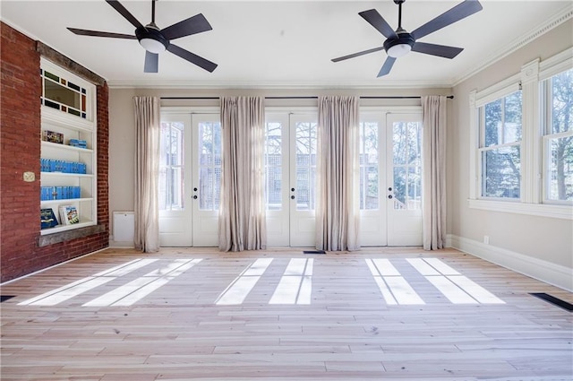 doorway featuring french doors, light wood-style flooring, a ceiling fan, and plenty of natural light