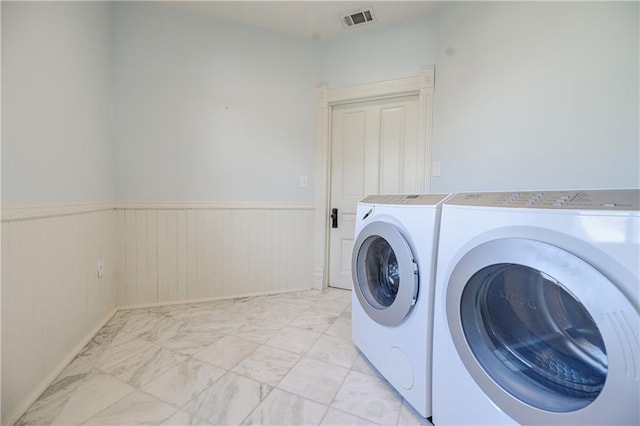 washroom with washing machine and dryer, visible vents, laundry area, wainscoting, and marble finish floor