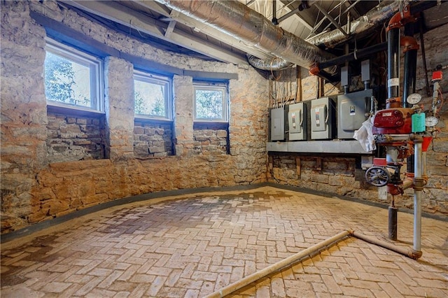 below grade area featuring brick floor and electric panel