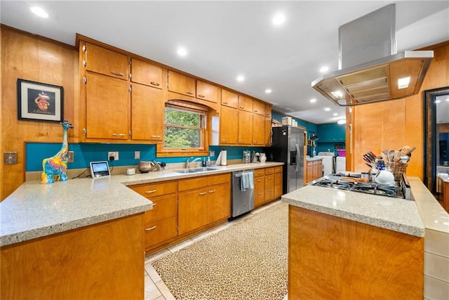 1138 Berkeley Rd, Avondale Estates, GA 30002 - kitchen featuring washing machine and dryer, appliances with stainless steel finishes, wall chimney range hood, brown cabinets, and a sink