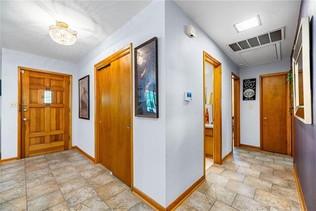 1138 Berkeley Rd, Avondale Estates, GA 30002 - entryway featuring stone tile floors, baseboards, and a chandelier
