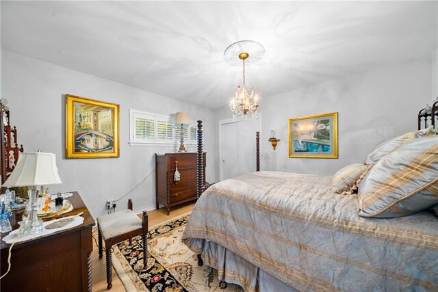 1138 Berkeley Rd, Avondale Estates, GA 30002 - bedroom with light wood-type flooring and a chandelier