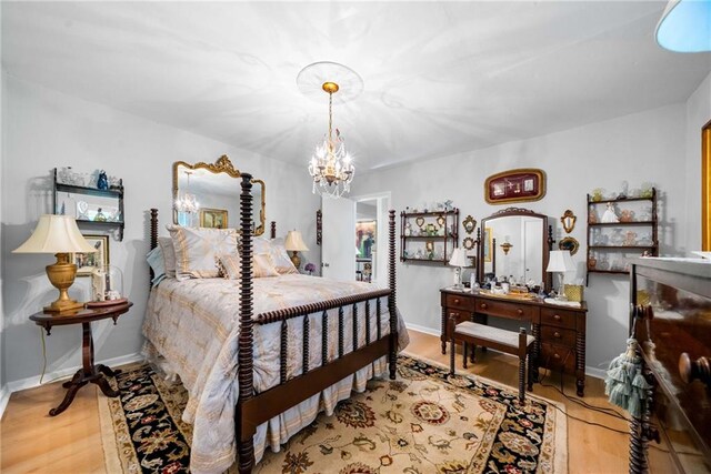 1138 Berkeley Rd, Avondale Estates, GA 30002 - bedroom with wood finished floors, a chandelier, and baseboards