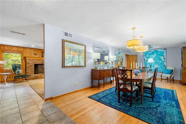 1138 Berkeley Rd, Avondale Estates, GA 30002 - dining space with a chandelier, baseboards, a fireplace, and wood finished floors