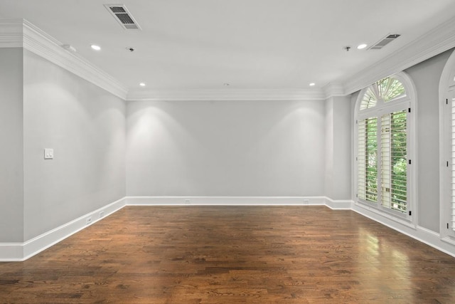 empty room with crown molding and dark wood-type flooring