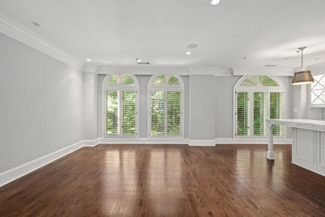 unfurnished living room featuring crown molding and dark hardwood / wood-style floors