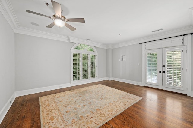 empty room featuring ornamental molding, dark hardwood / wood-style floors, and a healthy amount of sunlight