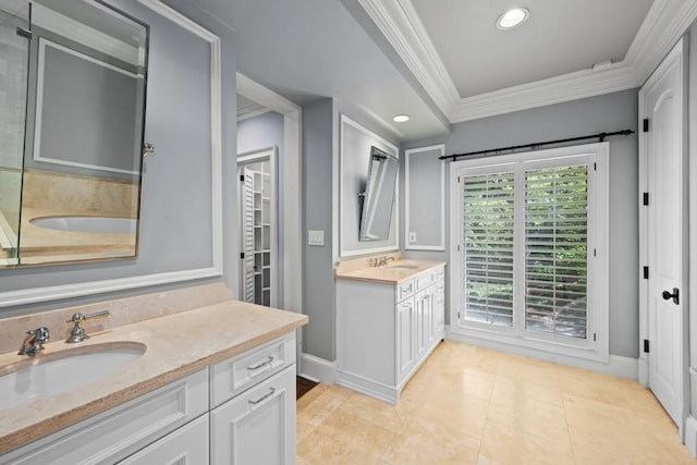 bathroom featuring vanity, a bathtub, tile patterned floors, and ornamental molding