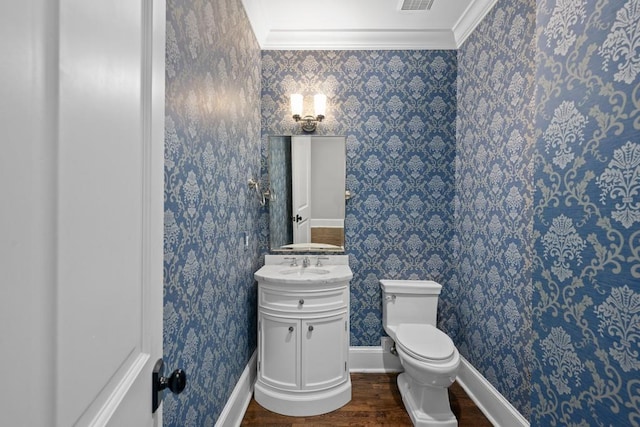 bathroom featuring vanity, crown molding, wood-type flooring, and toilet