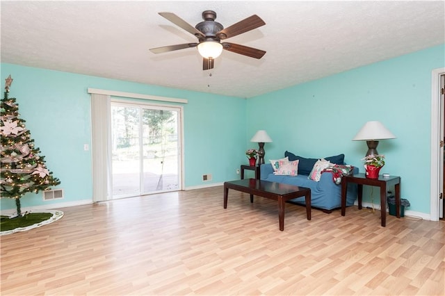 sitting room featuring light wood-type flooring and ceiling fan