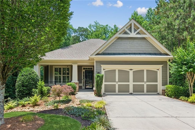 328 Shade Tree Cir, Woodstock, GA 30188 - craftsman-style home featuring concrete driveway, a garage, covered porch, a standing seam roof, and roof with shingles