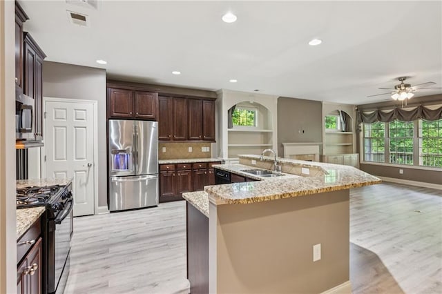 328 Shade Tree Cir, Woodstock, GA 30188 - kitchen with black appliances, light wood-style floors, open floor plan, ceiling fan, and recessed lighting