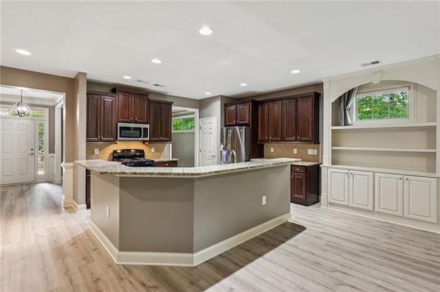 328 Shade Tree Cir, Woodstock, GA 30188 - kitchen with stainless steel appliances, light wood-type flooring, dark brown cabinetry, decorative backsplash, and recessed lighting