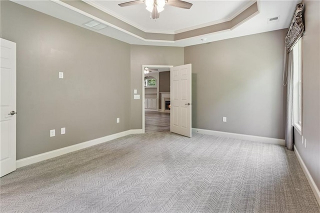328 Shade Tree Cir, Woodstock, GA 30188 - empty room with a tray ceiling, light colored carpet, a ceiling fan, healthy amount of natural light, and crown molding