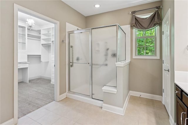328 Shade Tree Cir, Woodstock, GA 30188 - bathroom with a shower stall, vanity, a walk in closet, and tile patterned floors