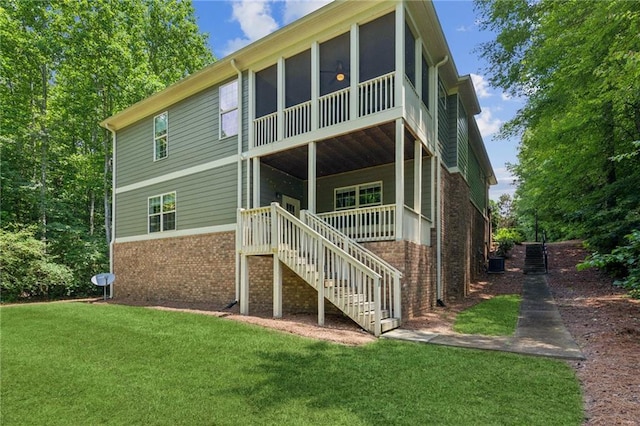 328 Shade Tree Cir, Woodstock, GA 30188 - rear view of house with brick siding, stairs, a lawn, and a sunroom