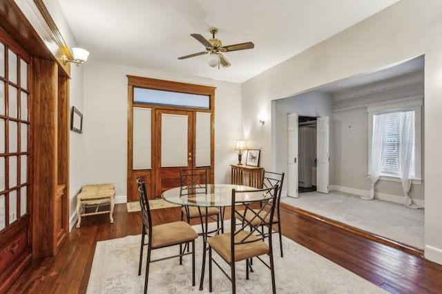 dining area with dark hardwood / wood-style floors and ceiling fan