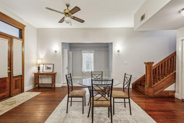 dining area with ceiling fan and dark hardwood / wood-style floors