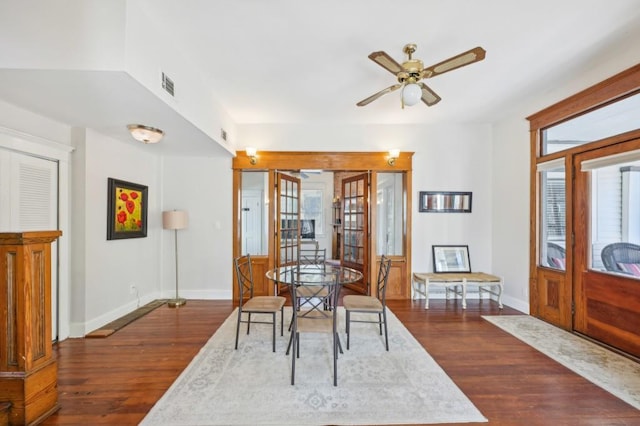 dining area with visible vents, baseboards, ceiling fan, and dark wood-type flooring