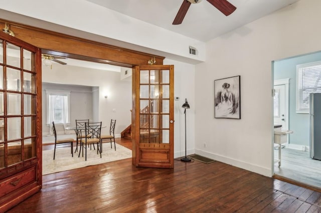 interior space featuring dark wood-type flooring and ceiling fan