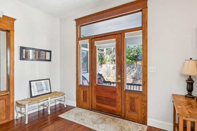 entrance foyer featuring baseboards and wood finished floors