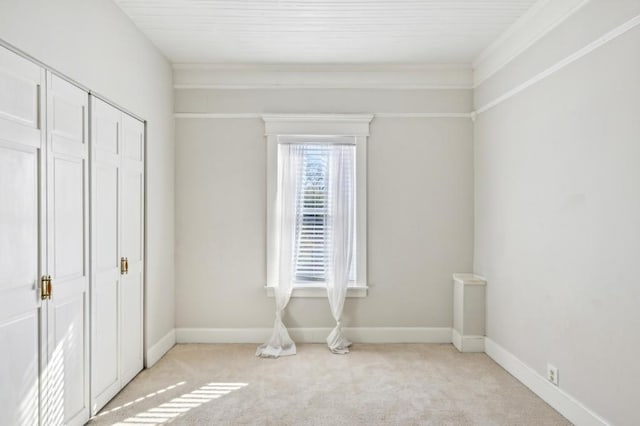 unfurnished bedroom with light carpet, a closet, and baseboards