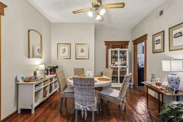 dining space with dark wood-type flooring and ceiling fan