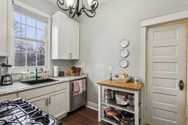 kitchen featuring white cabinetry, dishwasher, and light stone counters