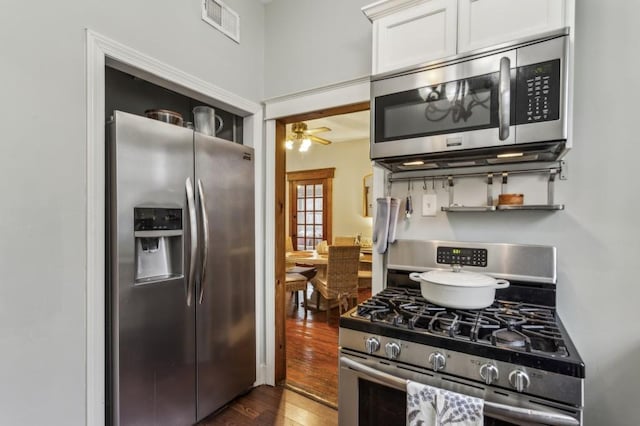 kitchen featuring white cabinetry, ceiling fan, stainless steel appliances, and dark wood-type flooring