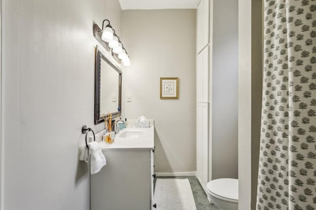 bathroom with vanity, walk in shower, tile patterned floors, and toilet