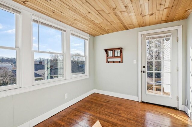 doorway to outside with wooden ceiling, baseboards, and wood finished floors