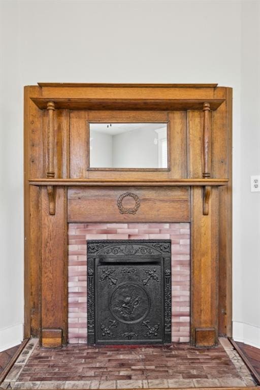 interior details with a tile fireplace and baseboards