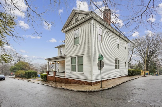 view of side of home with a porch