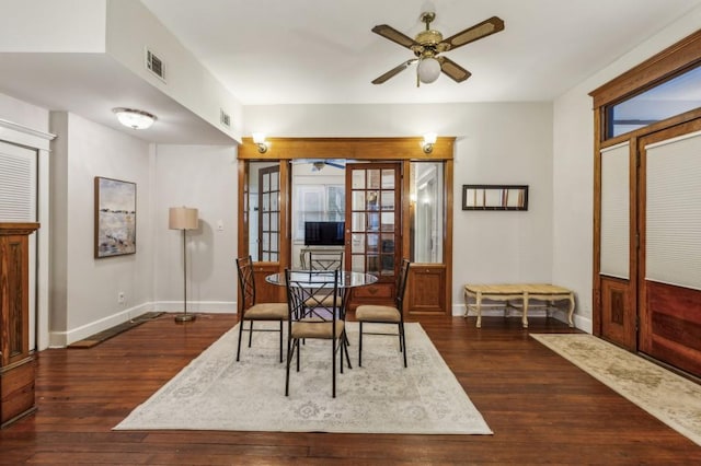 dining room featuring a healthy amount of sunlight, dark wood-type flooring, and ceiling fan