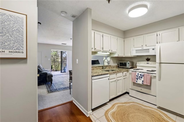 300 Johnson Ferry Rd NE Unit A313, Atlanta, GA 30328 - kitchen with white appliances, white cabinets, light stone counters, and light wood-type flooring