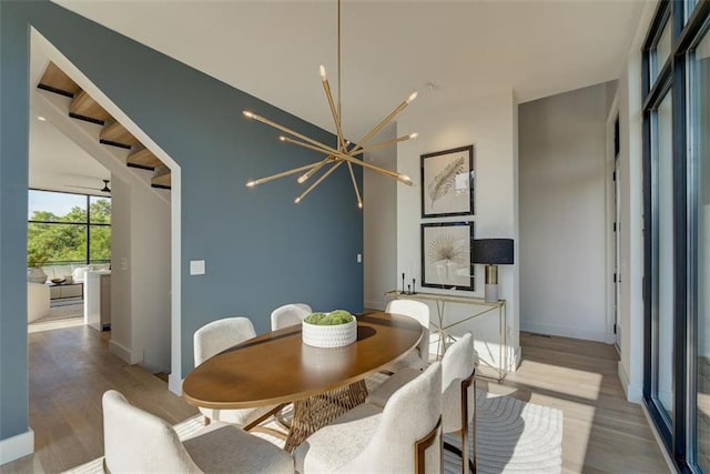 816 Berne St Unit 6, Atlanta, GA 30316 - dining area featuring light wood-style flooring, baseboards, and a chandelier