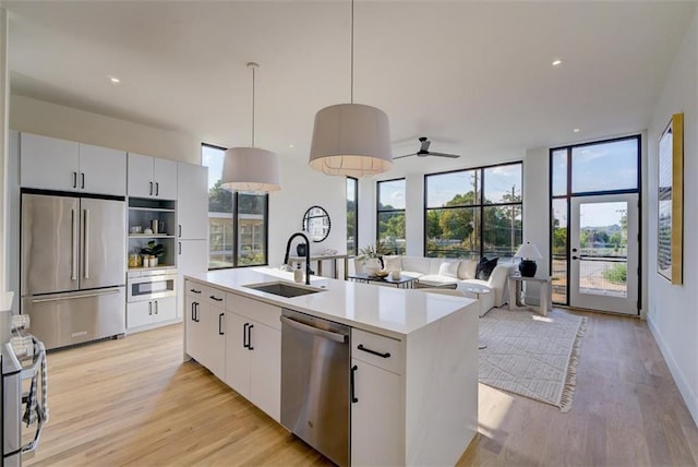 816 Berne St Unit 6, Atlanta, GA 30316 - kitchen featuring appliances with stainless steel finishes, a sink, light wood-style flooring, light countertops, and ceiling fan