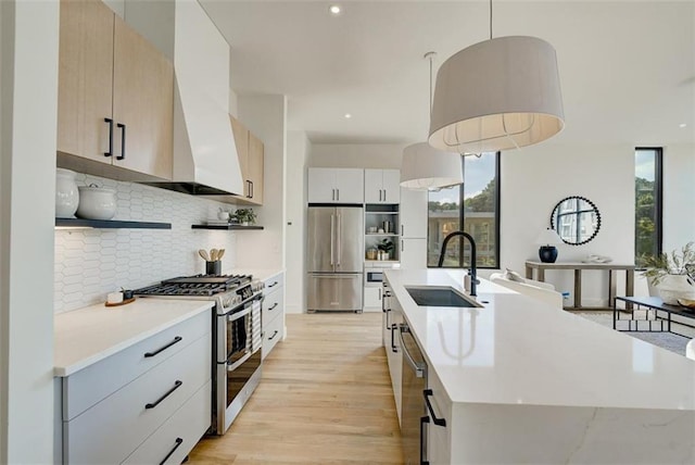 816 Berne St Unit 6, Atlanta, GA 30316 - kitchen with stainless steel appliances, custom range hood, a sink, tasteful backsplash, and a center island with sink