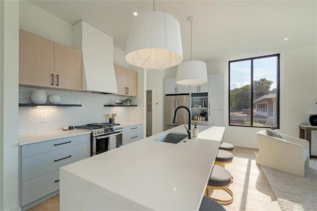 816 Berne St Unit 6, Atlanta, GA 30316 - kitchen featuring appliances with stainless steel finishes, a sink, open shelves, backsplash, and light wood-style floors