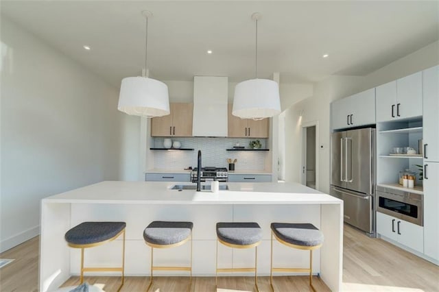 816 Berne St Unit 6, Atlanta, GA 30316 - kitchen featuring appliances with stainless steel finishes, a sink, tasteful backsplash, a kitchen bar, and recessed lighting
