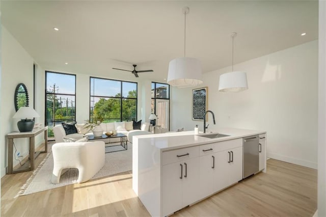 816 Berne St Unit 6, Atlanta, GA 30316 - kitchen with dishwasher, a sink, light wood-type flooring, open floor plan, and white cabinetry