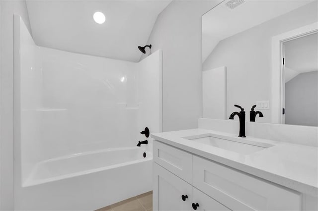 bathroom with lofted ceiling,  shower combination, vanity, and visible vents