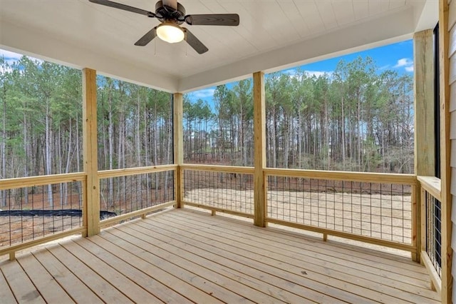 unfurnished sunroom with a ceiling fan